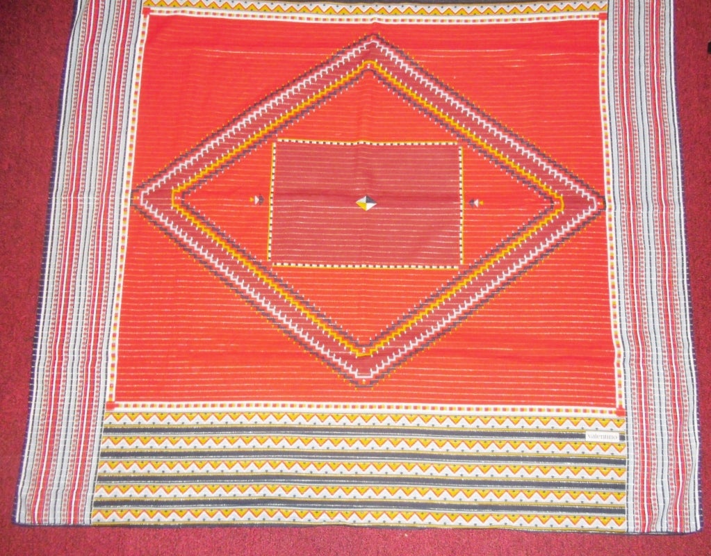 Pristine condition spectacular Valentino scarf.Basic vibrant red color with  demure gold stripes and  Indian motif print. Hand rolled edges.  100% fine cotton. 
Measures 52 