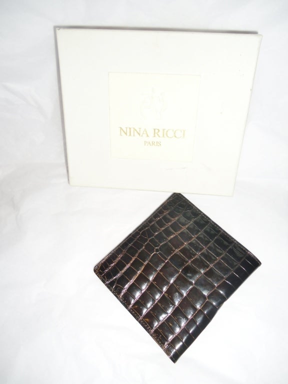 Never worn beautiful Nina Ricci Dark burgundy brown Bi-fold baby alligator wallet for man.3 compartments. Measures 4 by 4 1/4 closed . leather lined