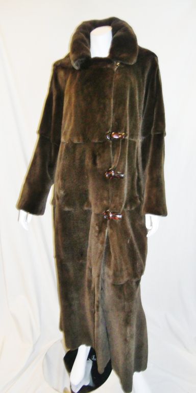 Beautiful dark brown Bob Mackie sheered mink fur coat. Layered look  design with stitched to give illusion of layers and scallops trim . In Fact coat is made of full female mink skins.  Tortoise front hooks closure. Detachable hood. Pristine