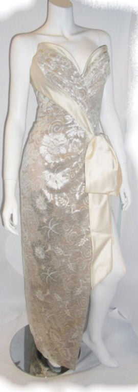Another spectacular Bob Mackie Creation! Nude color silk Georgette covered with cream lace. Boned corset crafted to a perfection!. Bust front pleats fold to the waist with a half bow finish. High side slit.
Couture item made for a celebrity. No