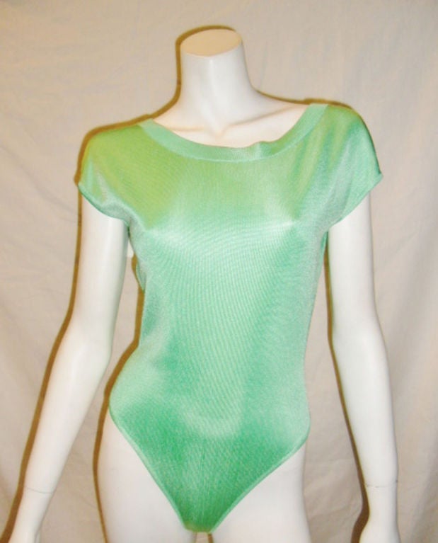 This is a fab vintage body suit, top by Azzedine Alaia, dating to the 1980s. It is slinky, jersey, cap sleeves.The leotard has a snap crotch and a wide thong back. Back Snap closure  It is made in France, size small. rn The measurements are:rn34