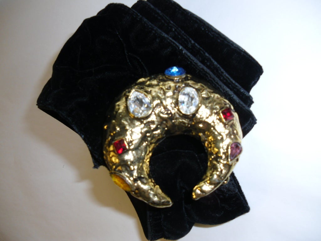 Extra beautiful Yves  Saint Laurent Specatcular Jeweled Vintage Belt. Black Velvet sash attached to one the most amazing belt buckles . Very heavy Gild tone Brass casted  and hand hammered than set in  multi colored stones. . Signed  at the back. .