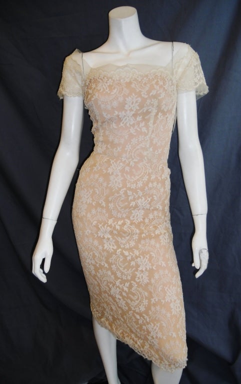 This exquisite 1950's original Peggy Hunt designer  features finely tailored Chantilly lace over nude lining with 
Dress features:
Classic illusion neckline over nude under dress
Sweetheart cut under dress
Square neckline, cap sleeves  and low