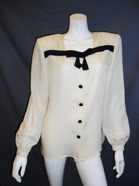Elegant and feminine ivory on ivory polka dots silk blouse by. Valentino. Black silk bow front detail with black silk covered buttons front closure. 
Size 42.us 8
Bust 42
length 25