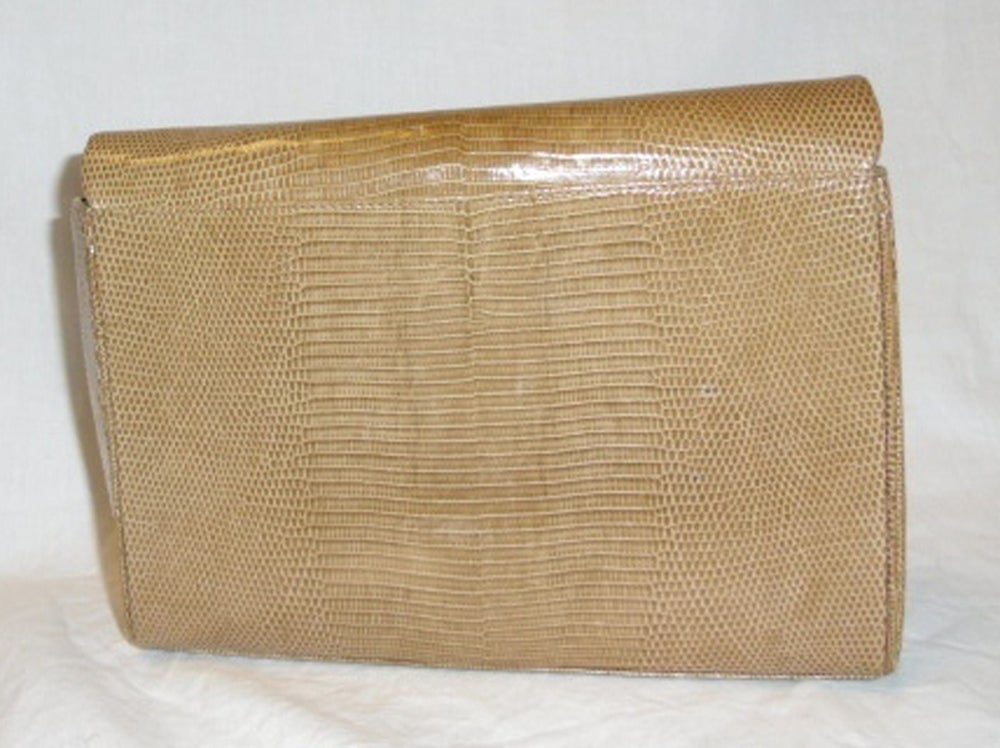 Tiffany Lizard Shoulder bag circa 1970's made in West Germany. In Excellent Condition. without any signs of wear and very rear bag by Tiffany and company. Fully Lined in leather and tan Lizard. Clasp Closure with a Gold Tiffany Logo and a removal