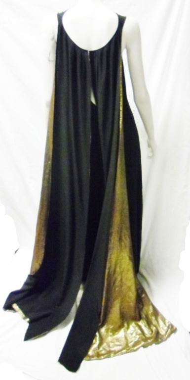 Extremely Karl Lagerfeld For Chloe 1978-1980 Goddess Gown. Black A line  gown with very low back. Scoop neckline lightly rushed.Hook and eye closure  to form two amazing panels at the back lined in antique  metallic gold  fabric. Very Karl Lagerfeld