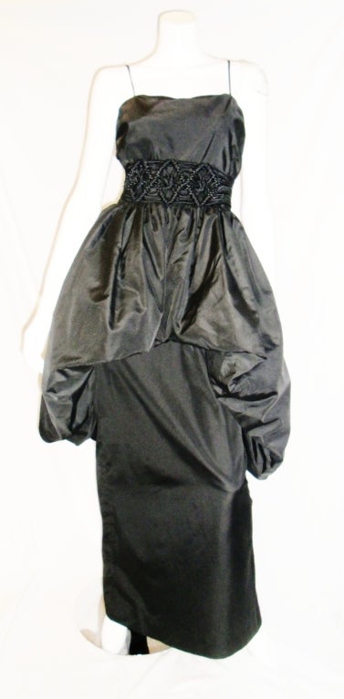 Lee Jordan New York Black vintage dress. Circa late 1970 early 1980. Silk Taffeta. Spaghetti straps  straight cut bodice with rushed sides  with very large bubble peplum.Pencil  floor length skirt with back slit. Pristine condition like new!  