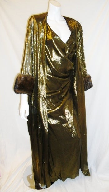 Absolutely stunning Nolan Miller gown  and over coat. Gold lame with  100% real mink. Dress is sleeveless side rushed, v neckline, fully lined , zipper back. No closure overcoat  with dramatic sleeves. Both pieces are size 20. Never used . purchased