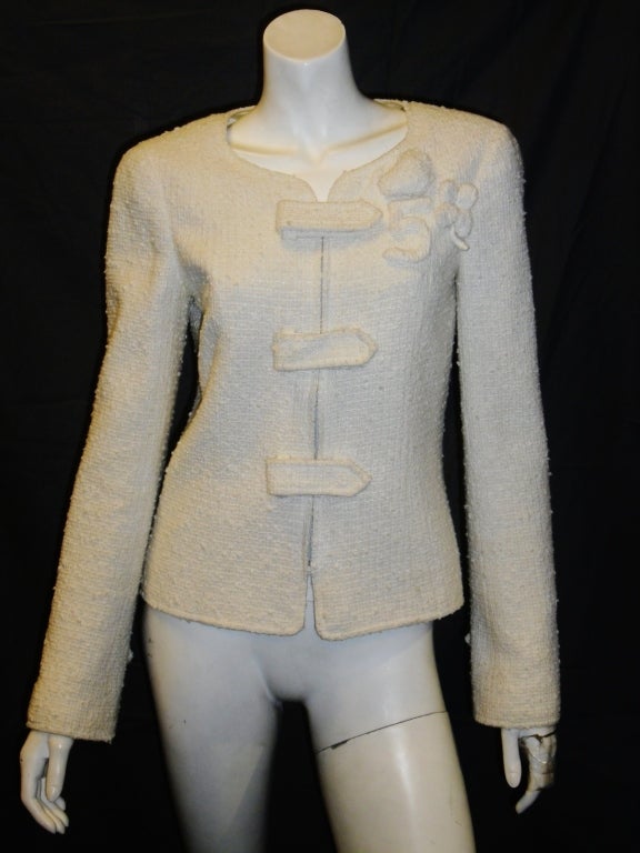 Beautiful white cotton  buckle Chanel jacket. Zipper front closure with three Velcro flap over straps. Same on the sleeves with slit.
Number 5, heart and clover on the left shoulder.
Silk cc logo  lining with silver chain at the bottom. 
Size