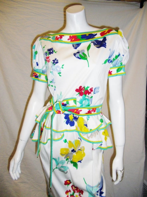 Beautiful and never worn Leonard Peplum Belted summer dress. Floral print on the soft crushed cotton. Green and yellow lining. Puffed short  sleeve. Red, yellow, powder blue, navy blue, powder green flowers. Pristine condition. Like ne!!
Bust 36'
