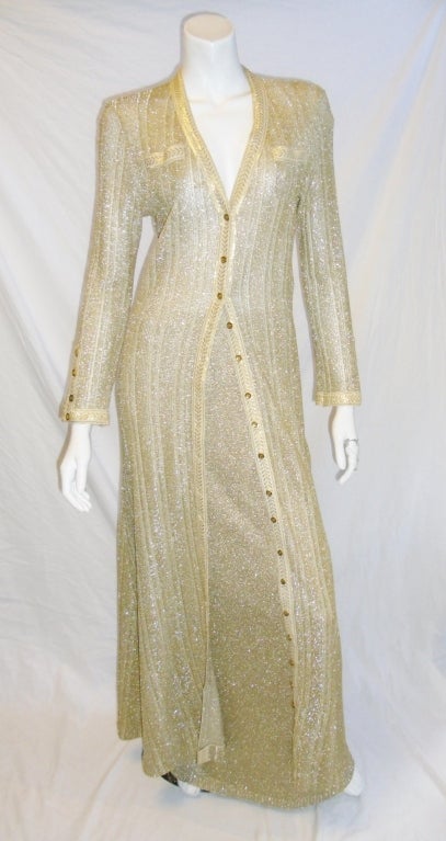 Circa 1970's Geoffrey Beene Vintage Bazaar  Gold knit  Duster Coat & Skirt Evening Ensemble. Delicate metallic knit long skirt and front button long coat / duster. in absolutely perfect condition without any pulls , holes or any damages.Trimmed with