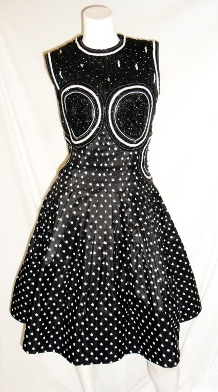 Beautiful Geoffrey Beene Beaded silk  Black & White Cocktail Dress. Entire bodice is doubled and heavily  hand beaded .Black and white silk taffeta stitch  pleated from under  the bust line created into a full skirt .  Hem reinforced with horsehair