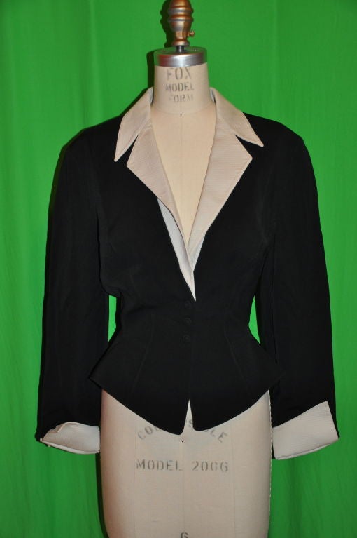 This Thierry Mugler black and pale gray viscose jacket is classic Mugler cut! On the jacket front, there are three snap closing covered with 