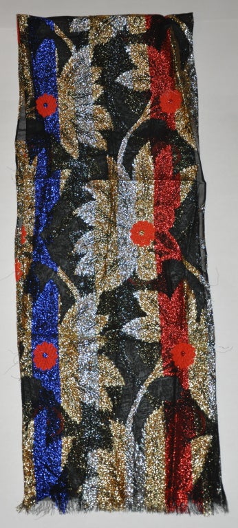 Yves Saint Laurent signature multi-color silk chiffon scarf has panels of multi-color metallic lame and highlighted with hand embroidered red silk flowers. The measurements are 9