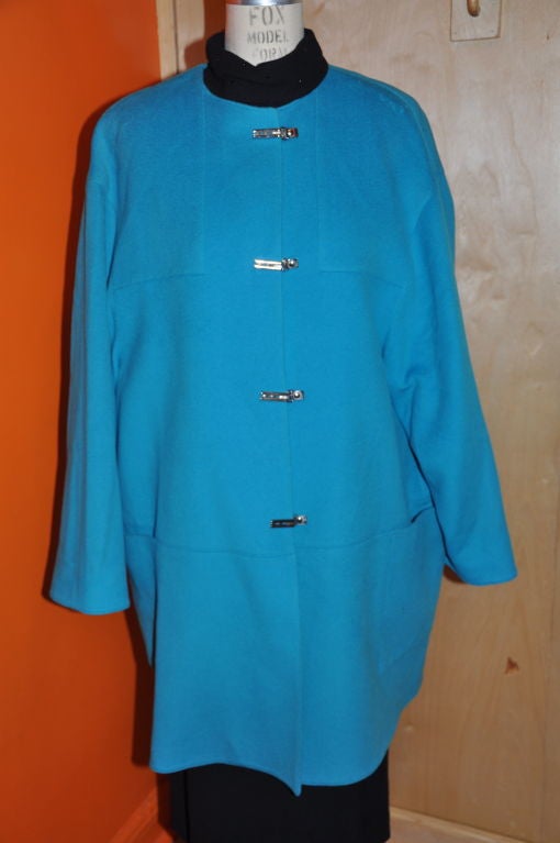        This wonderfully rare Claude Montana Turquoise Block car coat is geometric cut with two huge patch pockets in front. The detailing is beautifully stitched. This is a great coat to wear for a walk in the park to the museum. The felted wool is