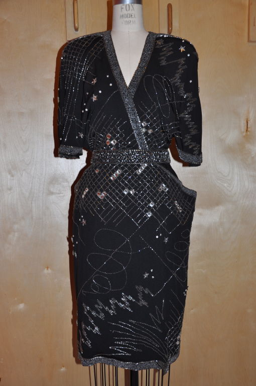 This Fabrice black evening dress is heavily embellished with seed size beads, bugle beads, and rhinestones in a explosive pattern. Great for the New Years! The shoulders are padded in the '80s style with butterfly sleeves. The fully lined dress is