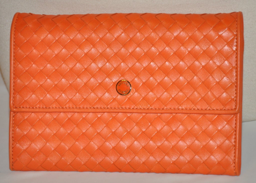 Bottega Veneta Tangerine woven lambskin leather clutch has optional shoulder straps if desired. The straps measures 64