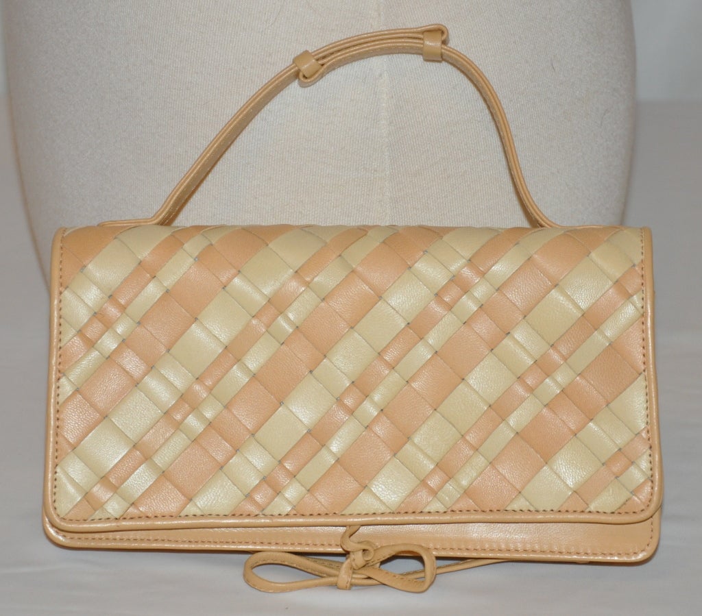 Bottega Veneta woven lambskin leather clutch with optional handle if desire to use as a handbag. The bag is in a combination of honey & cream hues woven together. 
  The bag opens accordian-style into a four-sectional along with a zippered