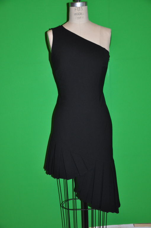 This Moschino couture black cocktail dress fits wonderfully to the body, and the pleating along the hem comes alive with every movement of the body! Elegant, yet sexy all at the same time. The fabric has a lycra blend and is dared at just the right