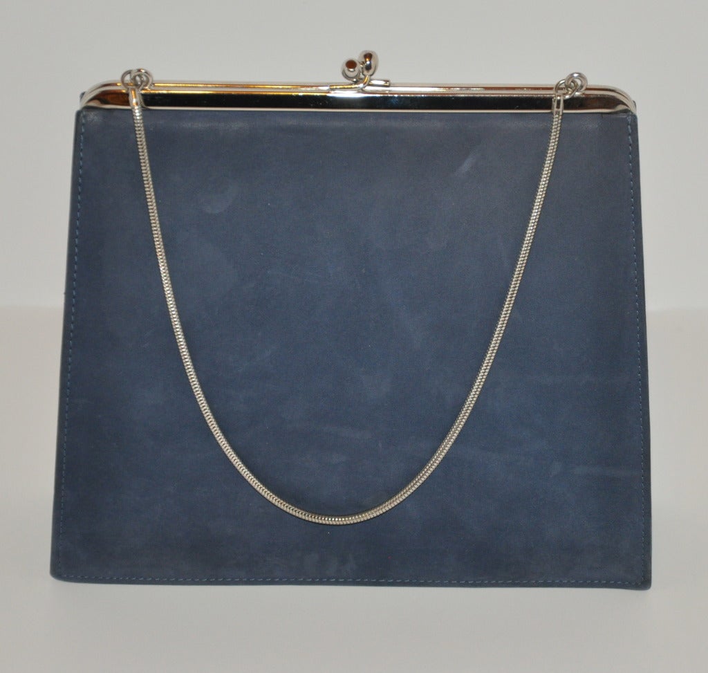 Denmark's Bon Gout Steel Blue Suede handbag is accented with silver-tone hardware and straps. The interior has a separate compartment along with a rectangle mirror. There's wonderful pleating on the front side of the handbag.
   The handbag