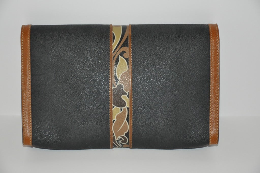 Leonard Textured Clutch with Floral accents is highlighted with calfskin on edges. This wonderful clutch can be use as a clutch, or as a shoulder bag with a calfskin strap measuring 65