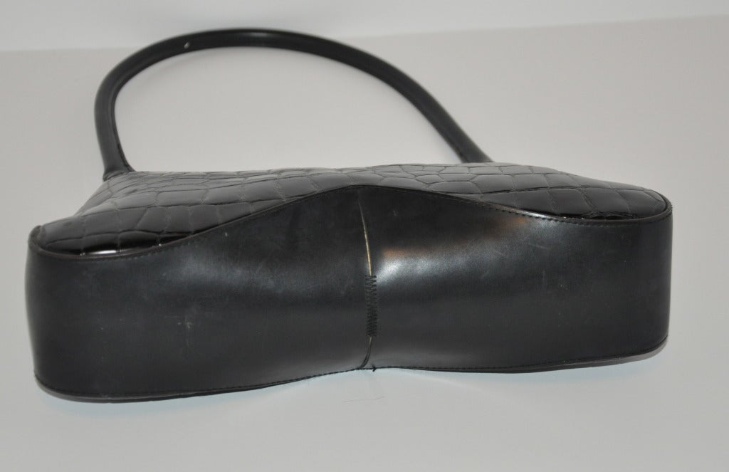Claude Montana Black textured leather has calfskin accents. Top opening zipper measures 9 1/2