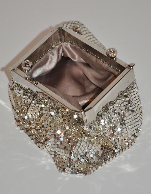 Vintage Whiting & Davis Silver-tone Mesh evening bag shapes like any other evening bag, until you open it! When opened, the opening is rectangle. The clasp is highlighted with two rhinestones. When closed, the evening bag measures 6