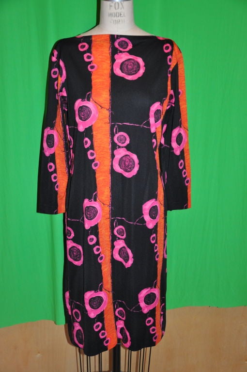 Abstract silk jersey boat neck silk jersey dress. This colorful floral abstract has colors of Fuchsia, Tangerine with black. The front is softly darted. Sleves length measures 19 
