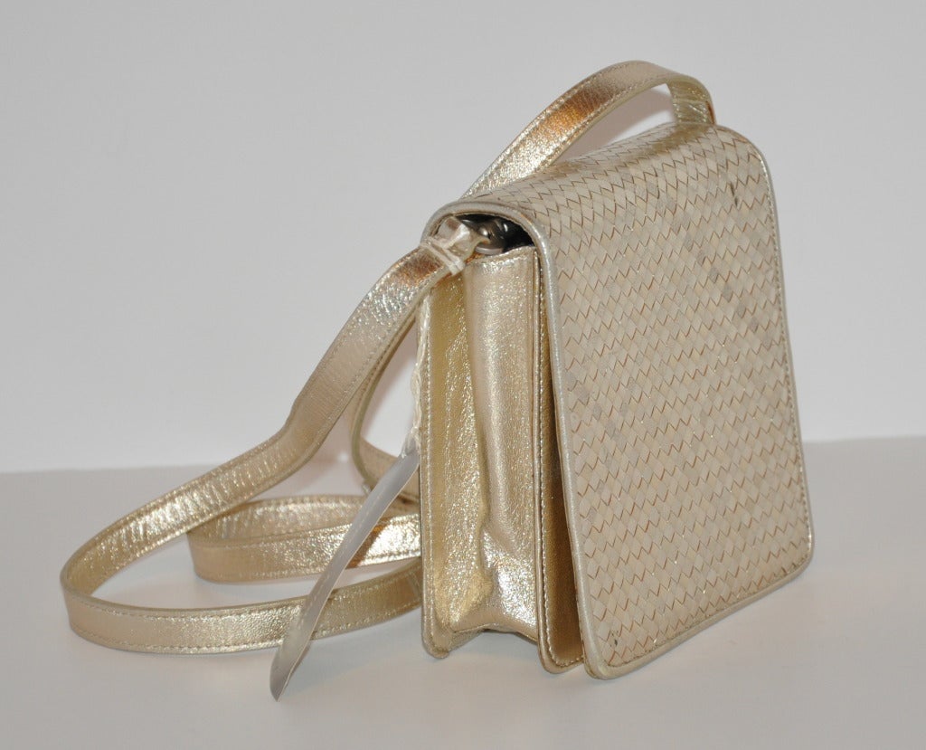 Stephane Kelian metallic-gold lambskin bag can be worn as a shoulder bag, or, after removing the straps, can be worn as a clutch.
   Bag measures at 6