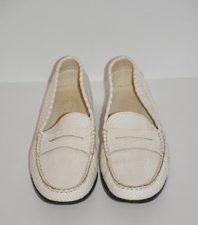 TOD's white snake-skin penny loafer-style shoes have butter-soft upper of snake-skin with leather soles in black.
   Size is 37 1/2 Italian, American 7 1/2 regular.
