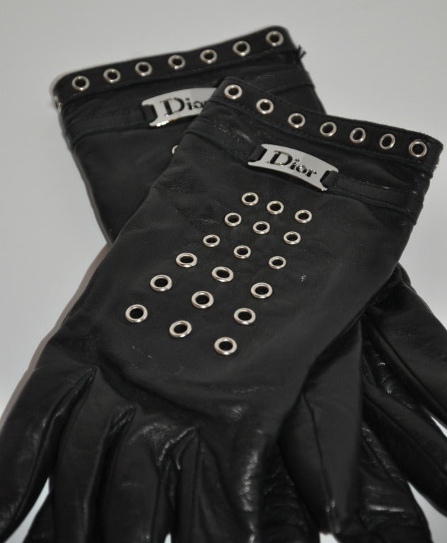 Christian Dior's black kidskin leather gloves has detailed silver hardware and eyelets. fully lined with black cashmere and size is 7.5