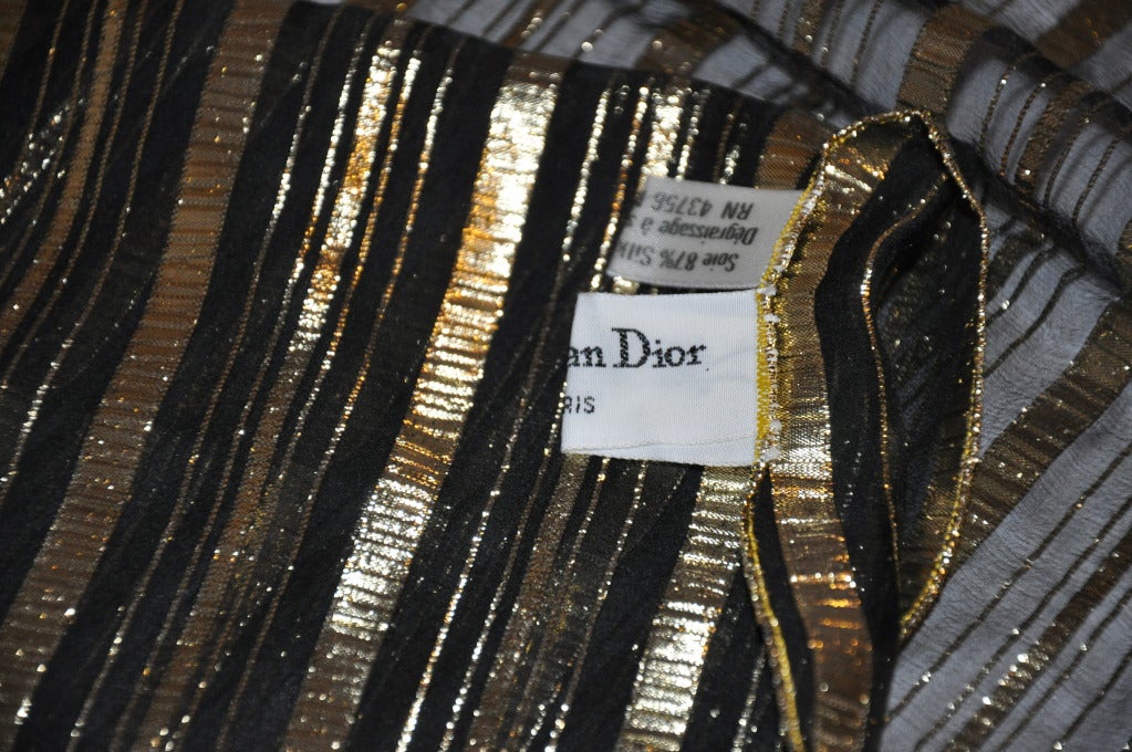 Christian Dior's elegant black & gold scarf is of gold lame and black silk chiffon. Edges are finished with gold lame threads. Rich and elegant, this makes for a 