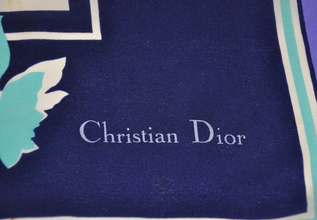 Christian Dior multicolored floral silk scarf has colors of navy, aqua, purple and white measures 25