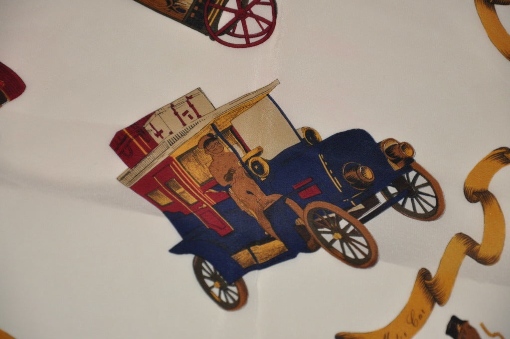 Transportation of planes, cars, carriages, and ships are just some that are shown on a cream-color silk chemise  scarf. Scarf measures 28 1/2