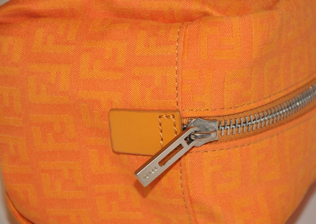 Fendi's Tangerine Monogramed Clutch In Excellent Condition For Sale In New York, NY