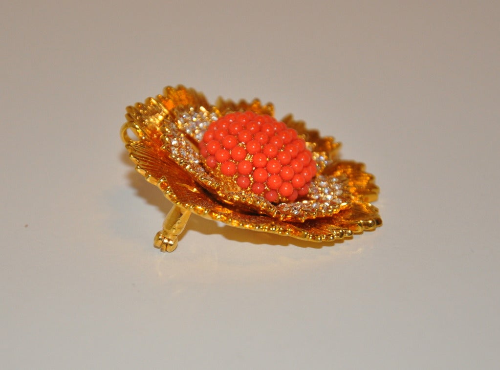 This heavily polished gilded gold hardware brooch and pendant is superbly embellished with richly faux coral and rhinestones in detail.
   Brooch/Pendant measures 1 5/8