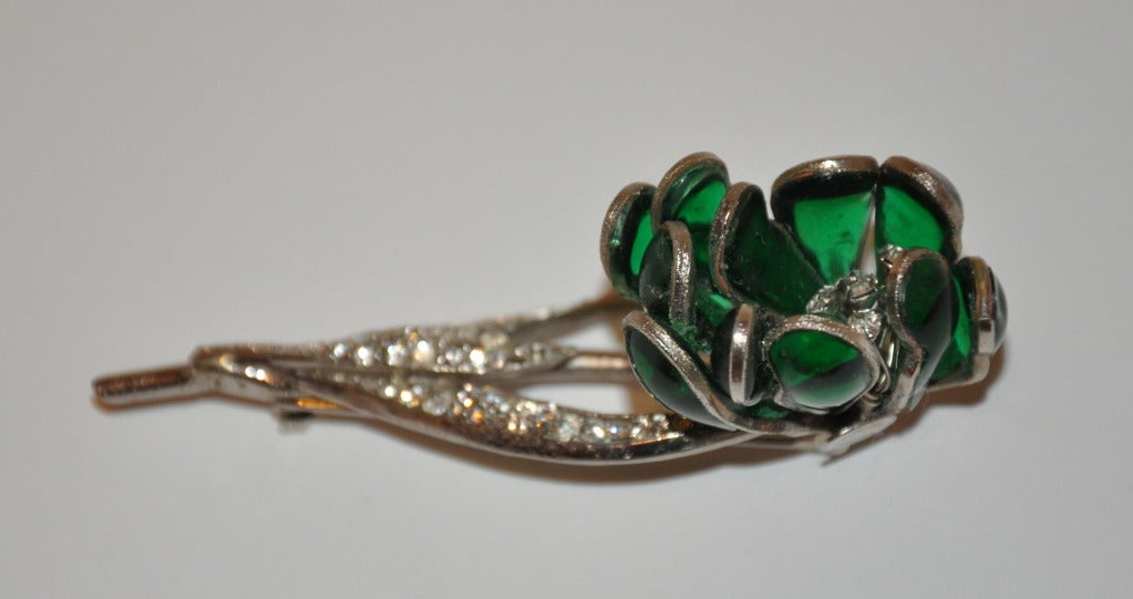 Hattie Carnegie large floral silver brooch set with rhinestones and green poured glass for petals and leaves. Brooch measures 3 1/4