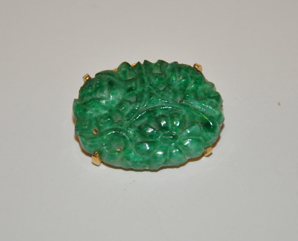 Marvella's gilded gold hardware frame brooch is centered with a faux jadeite stetched glass stone.
    Measurements are 1 1/4