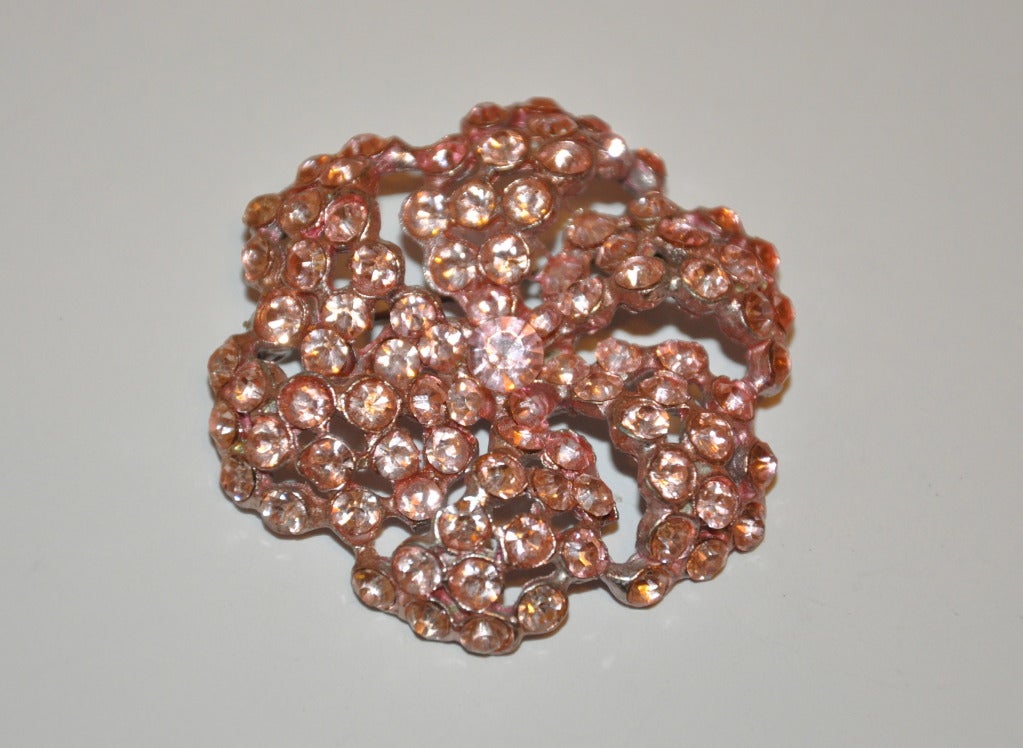 El gran broche floral adornado con brillantes rosas mide 5 cm de diámetro.