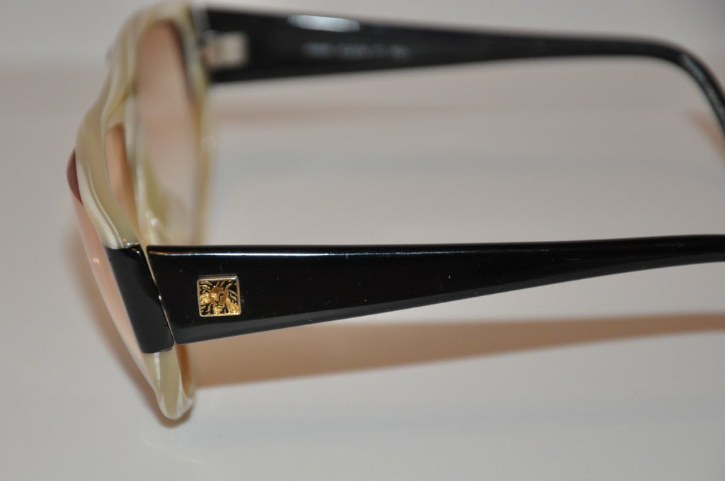 Anne Klein and tortoise shell sun glasses measures 2 inches in height and 5 3/4 inches across the front. The sides are 5 1/4 inches in length and accented with Anne Klein's signature logo on both sides of the sunglasses.