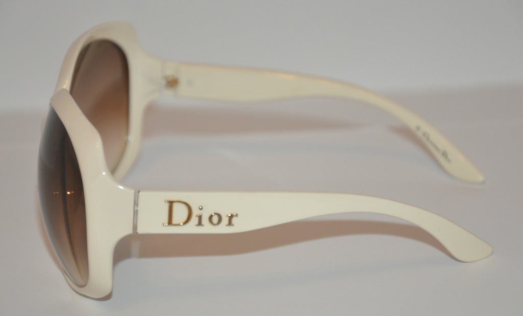 Christian Dior's cream colored lucite sunglasses has their signature 