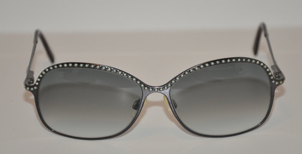 Lulu Guinness black framed sunglasses are studded with tiny pearls along the top of the rim.
   Glasses measures 2