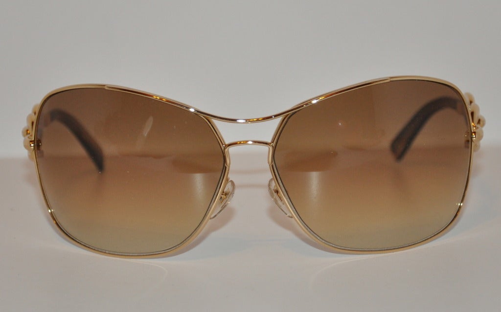 Gucci's signature logo in gilded gold hardware sunglasses measures 2 1/4