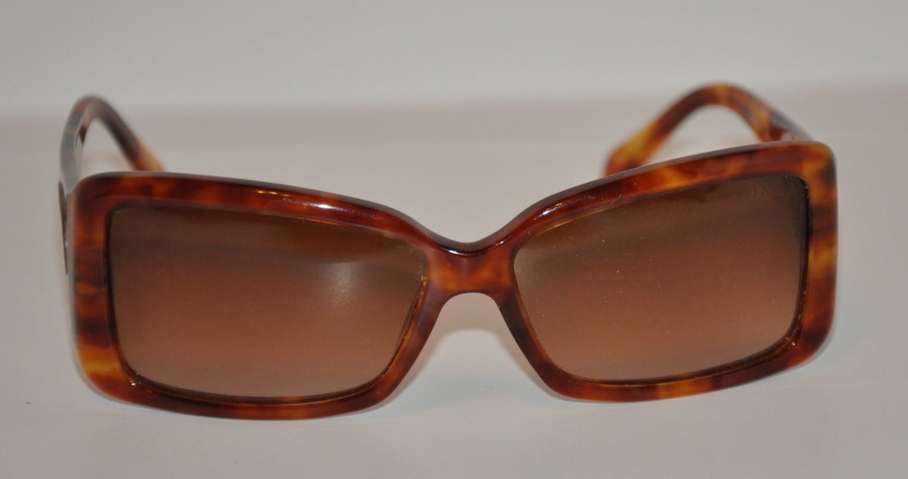 Tiffany & Co. tortoise shell sunglasses are combined with two large sterling silver 