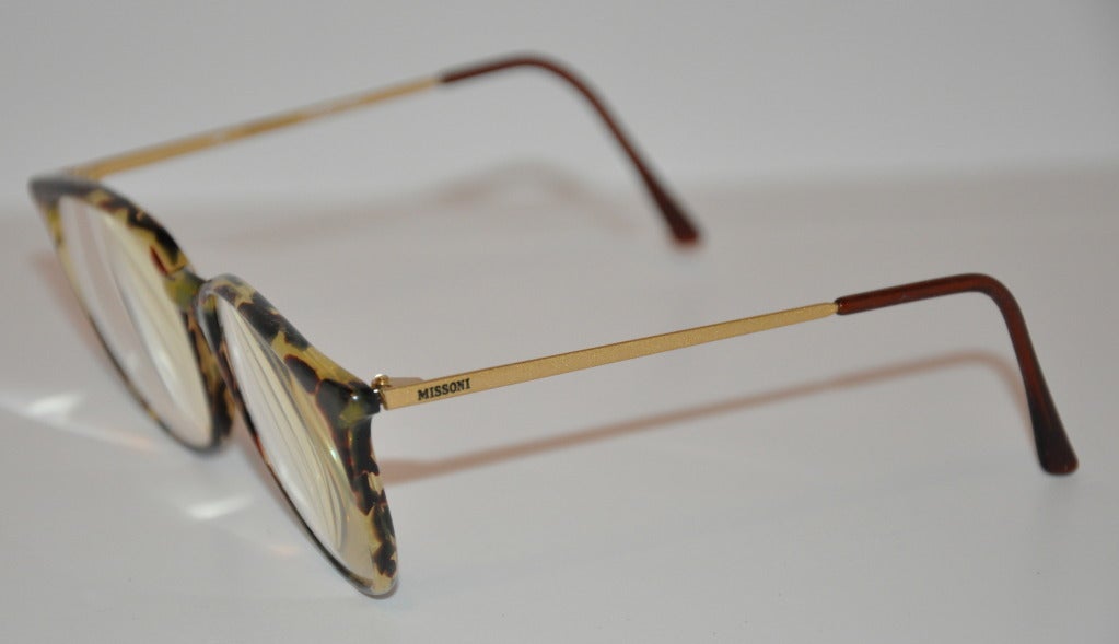 Missoni tortoise-shell glasses has gold hardware framed sides covered with plastic tips.
   Glasses measures 1 7/8