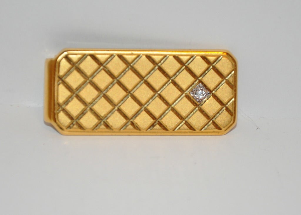 Yves Saint Laurent men's money clip in gold vermeil hardware finishing , engraved with diamond patterned & embellished with a .05 Kt diamond.
   Money clip measures 1 1/2