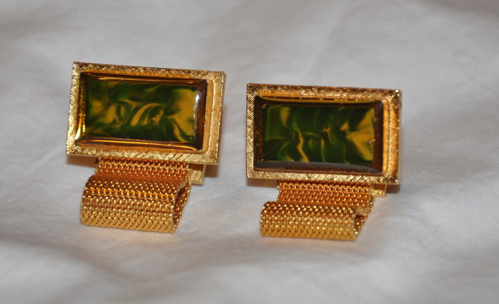 Poured glass with hues of green and pale gold accents this gilded-gold hardware cufflinks.
   Cufflinks measures 1 1/16