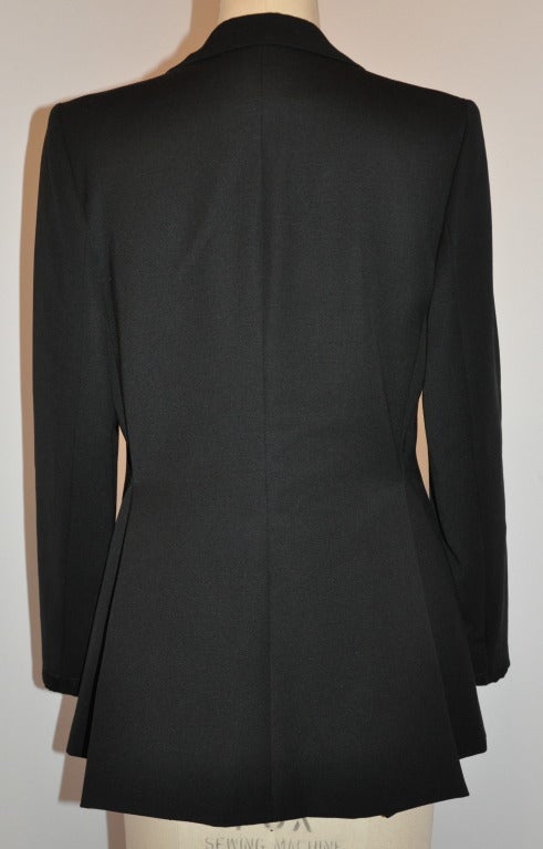        Dana cote D'azur's wonder classical black cocktail blazer of wool is accented with black satin lapels and cuff detailing. Fully lined with silk. The front of this wonderful piece is fashion with a single 