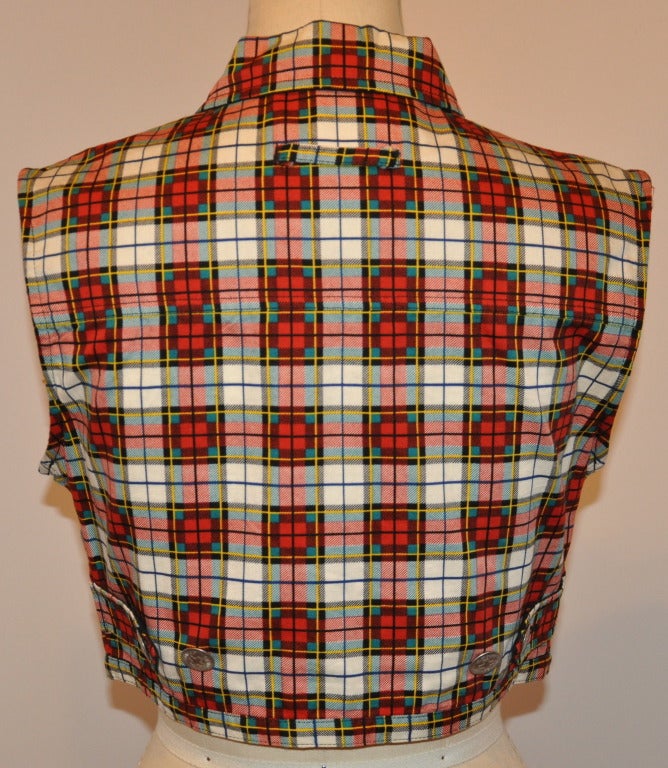 Jean Paul Gaultier plaid cropped button-down top has two breast pockets. Front length measures 13 inches, back is 15 inches. Neck-to-shoulder measures 5 inches, waist circumference is 30 inches, underarm circumference measures 36 inches.
   Shirt