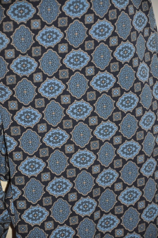 Prada's shades of blues print trousers has two hidden side pockets along with a single back pocket. There's a option for a belt if desired. 
   Pants are of cotton with a bit of lycra for a better fit where needed. 
   Outer seam waist-to-hem